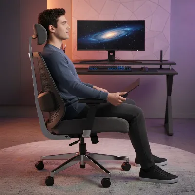 A person adjusting the height and recline of an ergonomic gaming chair