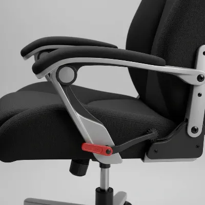 A close-up of a floor gaming chair highlighting its adjustable recline mechanism and comfortable padding.