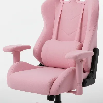 A close-up of a pink gaming chair highlighting its adjustable armrests, lumbar support, and plush material.