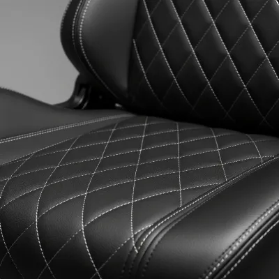 Close-up view of the Secretlab Titan Evo's NEO Hybrid Leatherette upholstery, highlighting its texture and durable stitching. The image also subtly shows part of the robust metal frame, emphasizing quality.